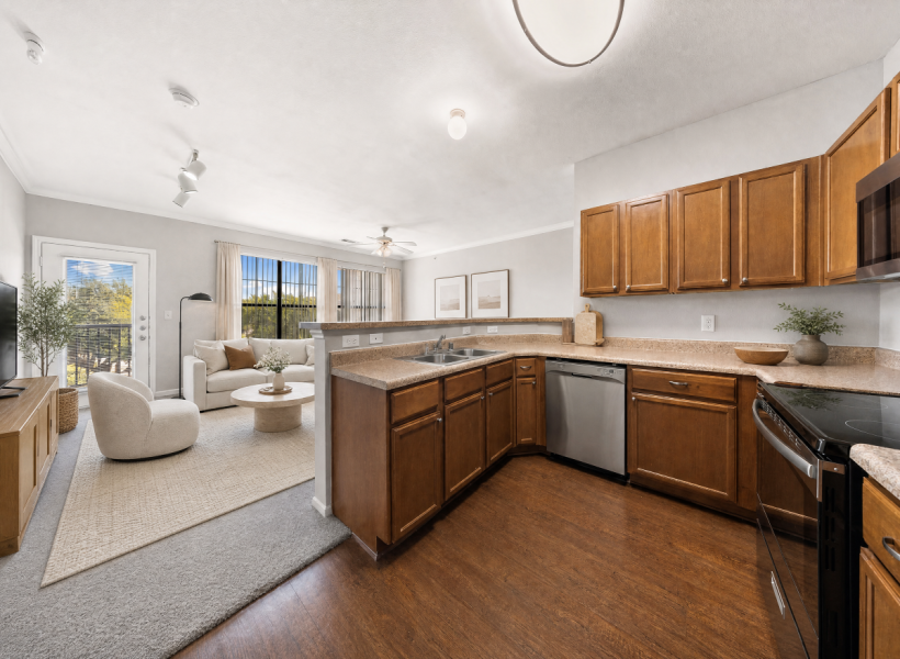 View of Furnished Living Room, Showing Couch, Décor, Adjacent Dining Room, Ceiling Fan and Entry Door at Toscana at Valley Ridge Apartments View of Furnished Living Room, Showing Couch, Décor, Adjacent Dining Room, Ceiling Fan and Entry Door at Toscana at Valley Ridge Apartments